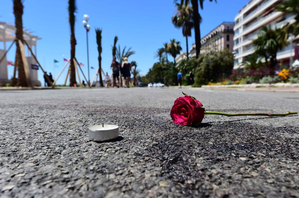  A single flower and a candle mark the spot where a person died during the Nice terror attack last Thursday