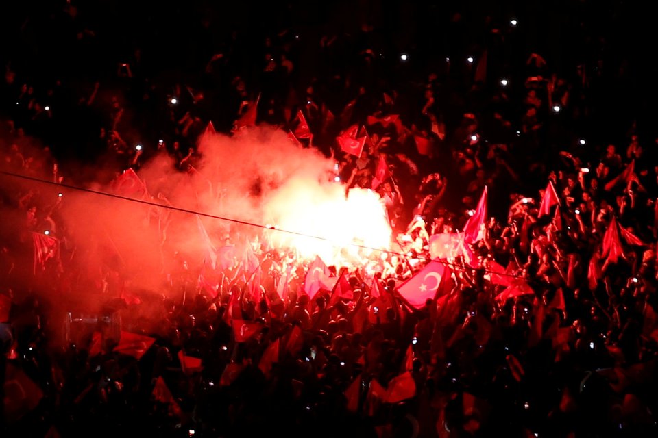  Supporters of Turkish President Tayyip Erdogan light flares during a pro-government demonstration on Taksim Square in Istanbul, Turkey, last night