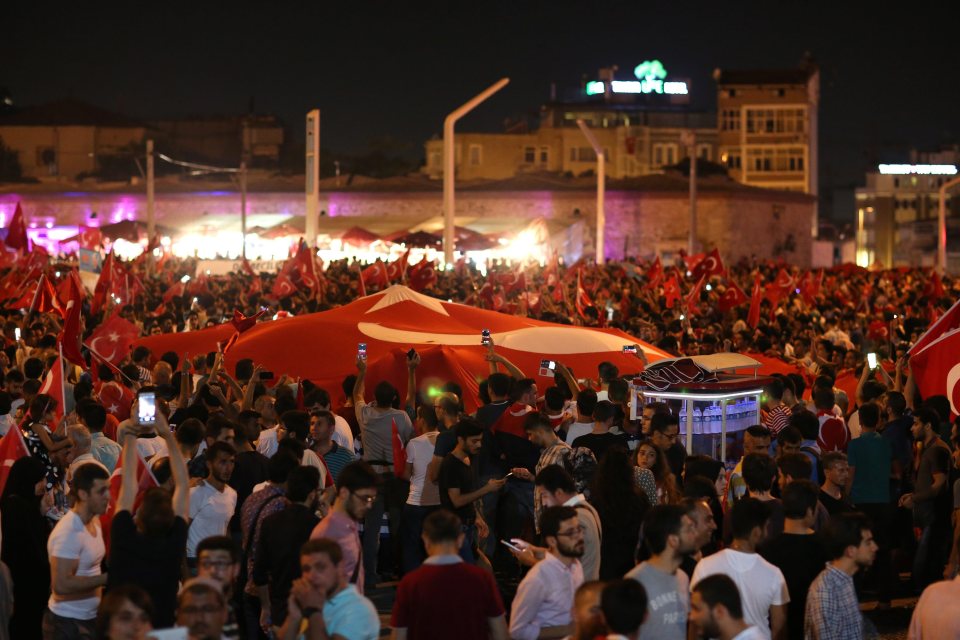  Supporters of Turkish President Recep Tayyip Erdogan shout slogans and hold flags during a demonstration in Taksim Square, Istanbul