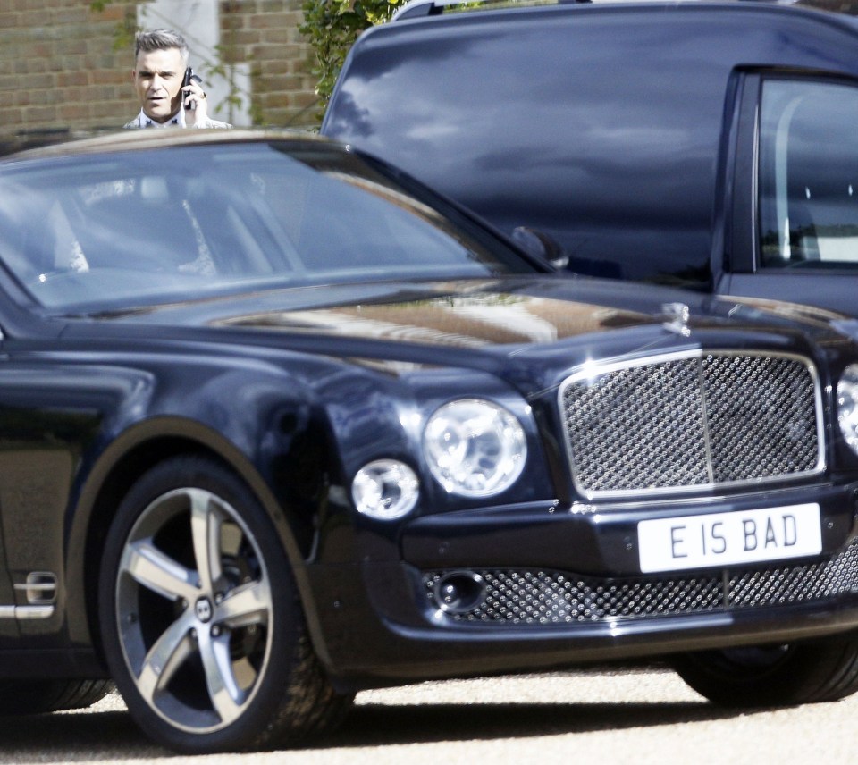  Robbie rocked up in style in a swish black Bentley