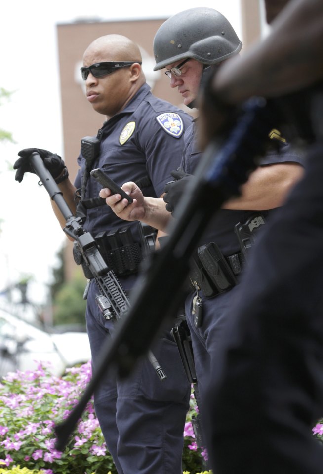  Armed colleagues stood guard at the hospital where the injured cops were being treated