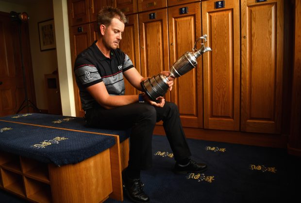 Henrik Stenson of Sweden looks at the Claret Jug in the Champions Locker Room following his win