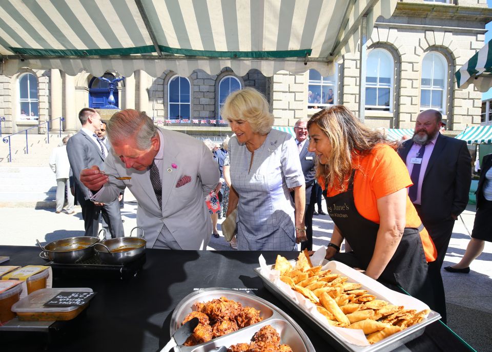  The Prince of Wales and the Duchess of Cornwall visited a farmers' market outside St. John's Hall in Penzance, where they tasted curry made locally