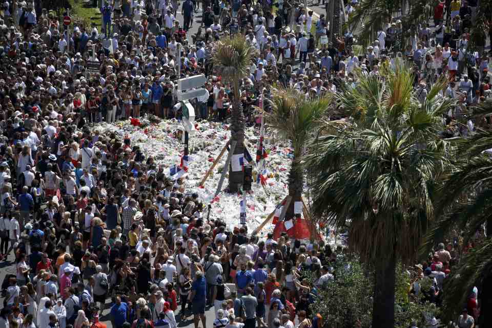  A view shows the crowd gathering near a makeshift memorial on the Promenade des Anglais to pay tribute to the Bastille Day massacre victims