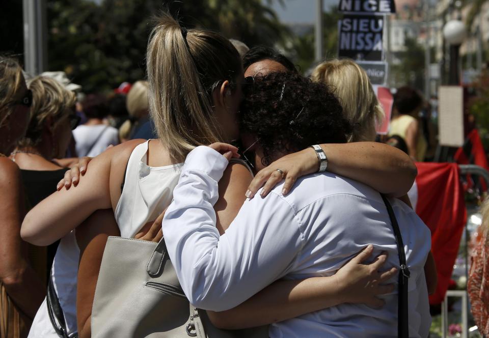  People hug on the Promenade des Anglais during the memorial to victims of the truck attack