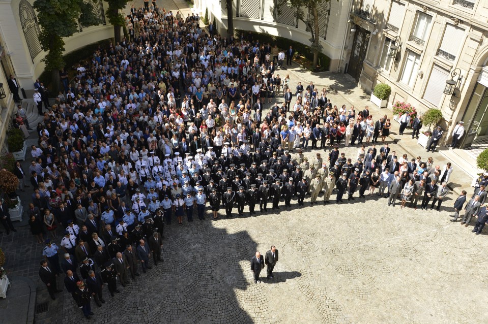  French President Francois Hollande and his Interior Minister Bernard Cazeneuve take part in a minute's silence at the Interior Ministry in Paris