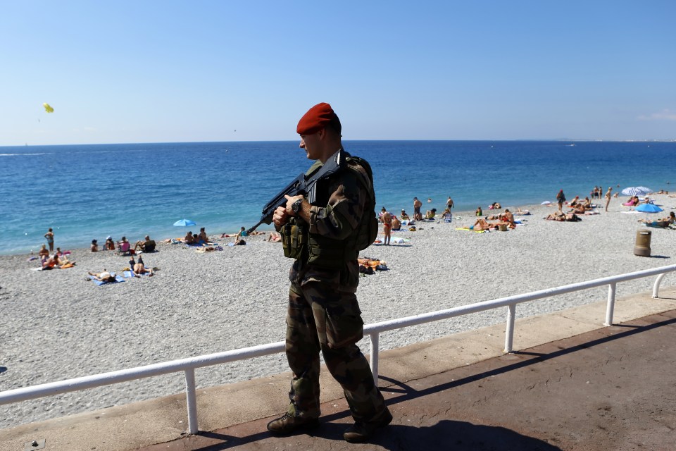  Tensions... a French soldier patrols during the minute's silence on the Promenade des Anglais in Nice