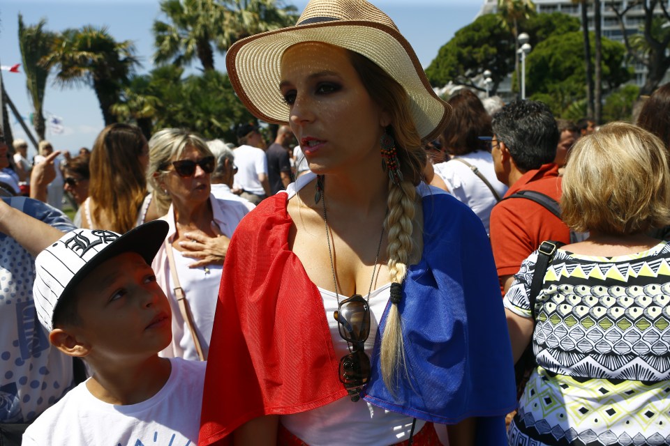  A woman wears a French flag during the tribute to the Nice terror attacks victims on the Promenade des Anglais