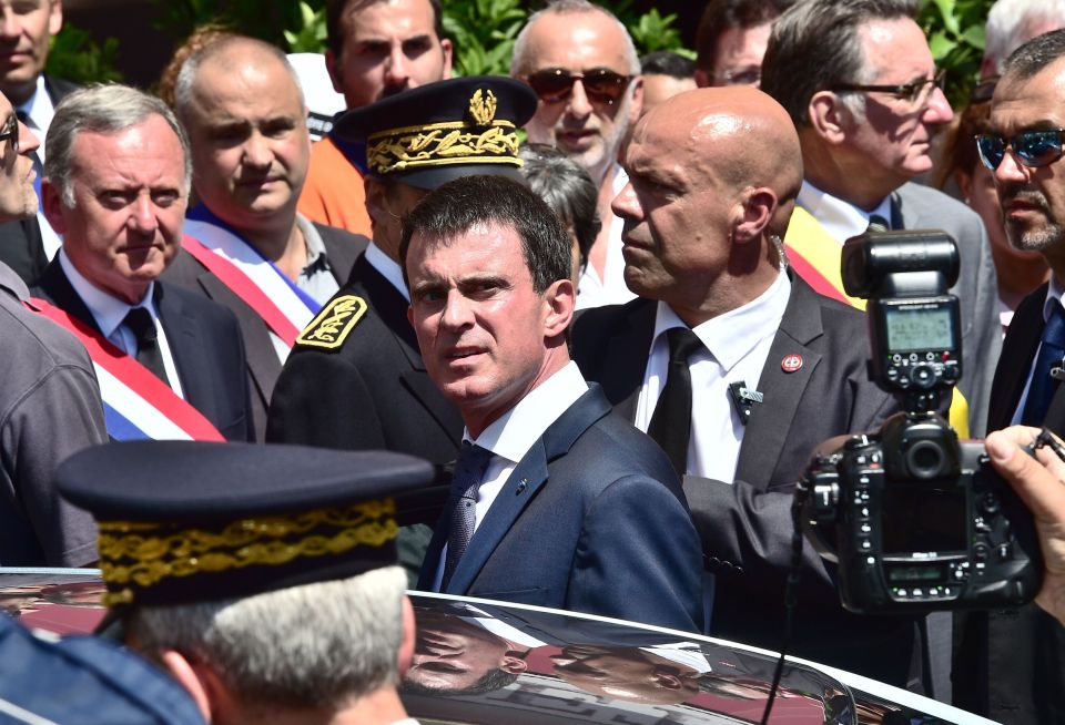  Quick getaway... French Prime Minister Manuel Valls leaves after a one minute's silence in Nice where he roundly booed by mourners