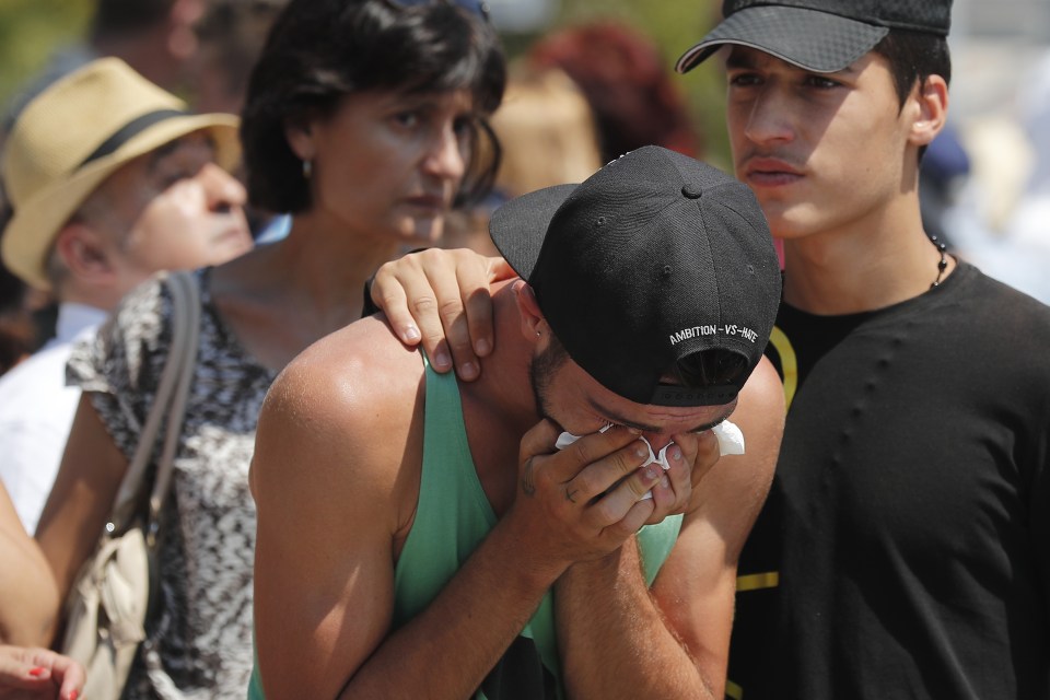  Grief... Mourners weep after a minute's silence at a memorial to the Bastille Day terror attack