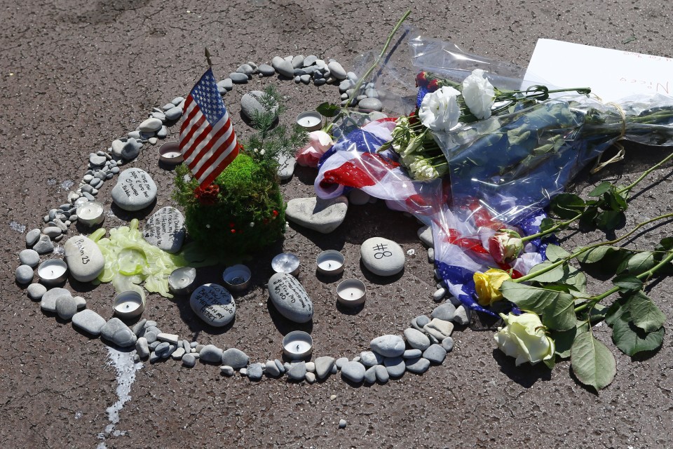  Tributes... flowers and candles with a U.S. flag are placed at the scene of a truck attack on the Promenade des Anglais in Nice