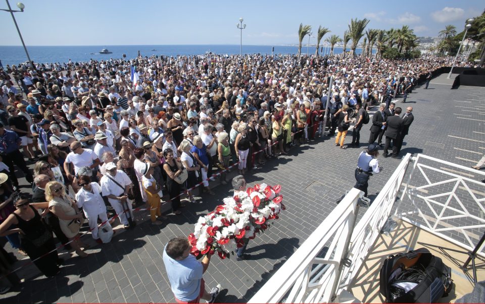  Mourners gather to observe a minute's silence in tribute to the victims of the deadly Nice attack at La Promenade des Anglais