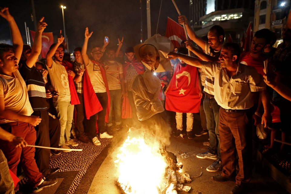  Men gather around the effigy in the aftermath of the attempted coup in Turkey