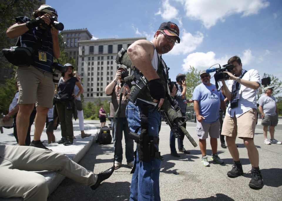  Meanwhile open carry activists gathered outside the venue and showed off their weapons