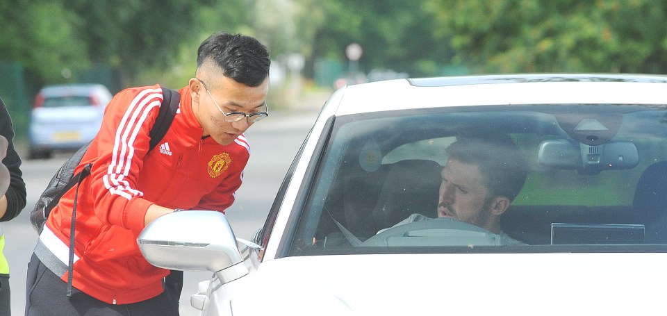  A fan stops Michael Carrick for an autograph on the way to training