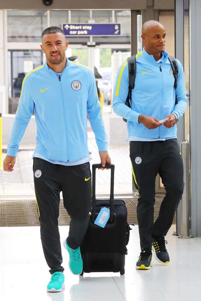 Defensive duo Aleksandar Kolarov and Vincent Kompany make their way to the plane