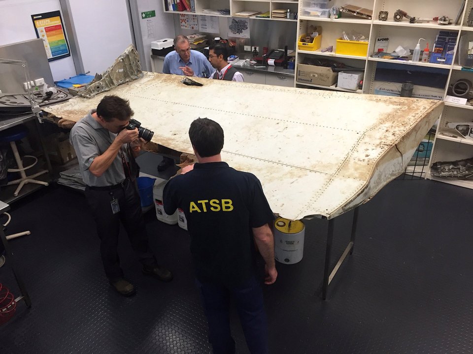  Australian and Malaysian officials examine aircraft debris