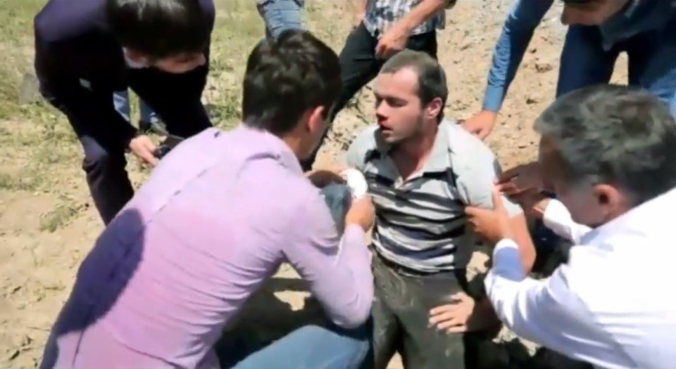  The man tries to sit up with witnesses helping to dab his bleeding nose as they wait for ambulance crews