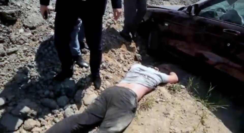  The man can be heard moaning with his face down in the dirt after surviving the horrific crash