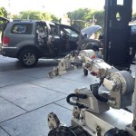  Scare tactics... a bomb robot is seen next to the SUV where the suspect had barricaded himself into. At one point, the machine was sent in by cops in a bid to force his surrender