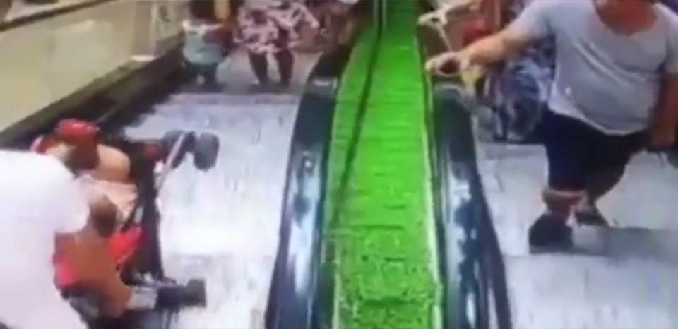  Footage shows the woman wheeling the buggy onto the escalator despite not being allowed