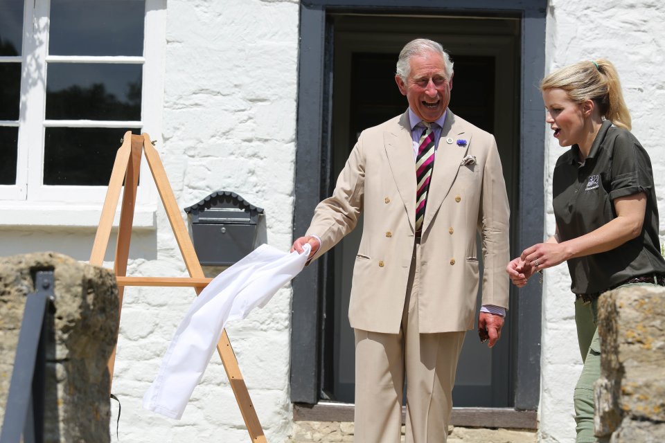  Countryfile presenter Ellie Harrison looks ready to pick the plaque up as Charles stands around chuckling