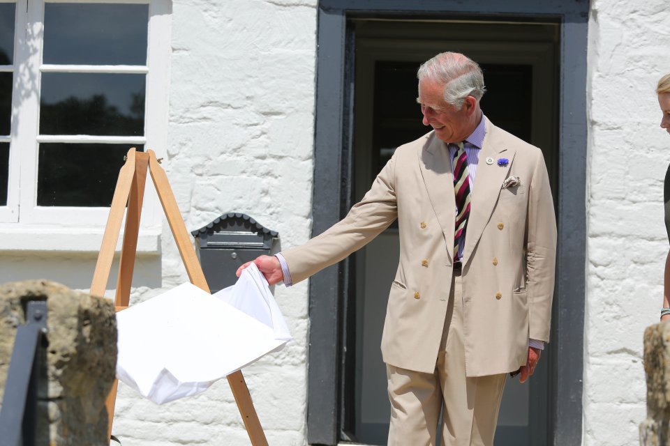  Whoops! Prince Charles makes no effort to catch the plaque after knocking it off its mount