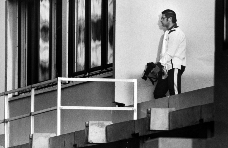  An armed German policeman, dressed as an athlete, stands around the corner from where the hostages were kept