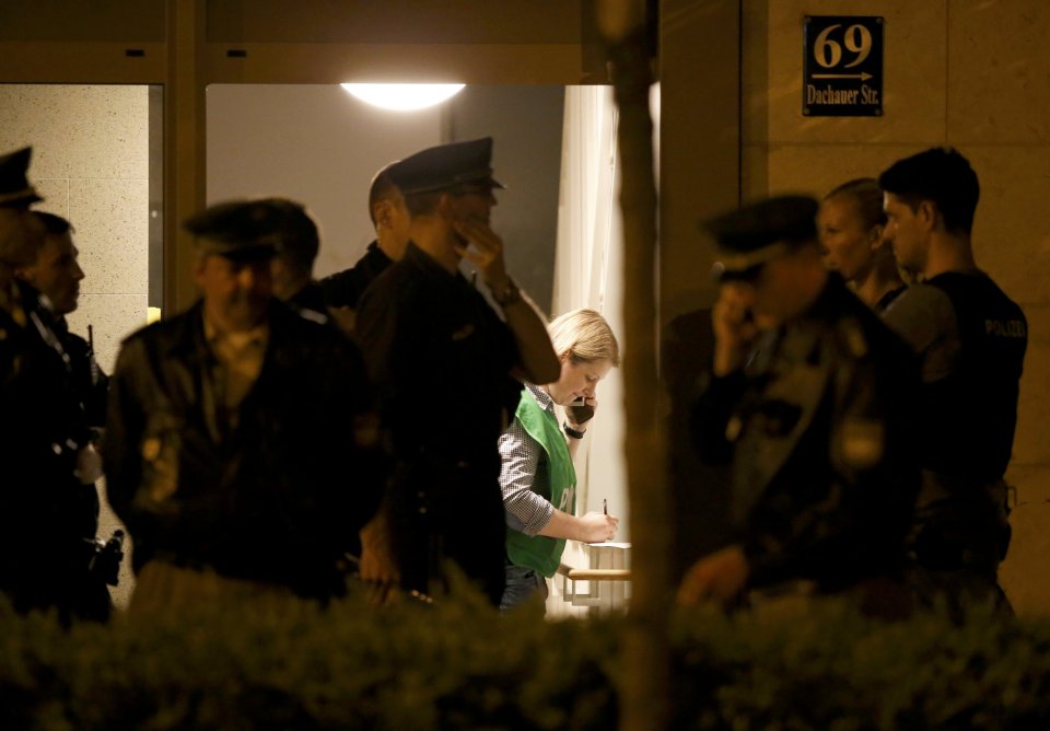  German cops were pictured searching an apartment in the early hours of this morning after the shooting in Munich