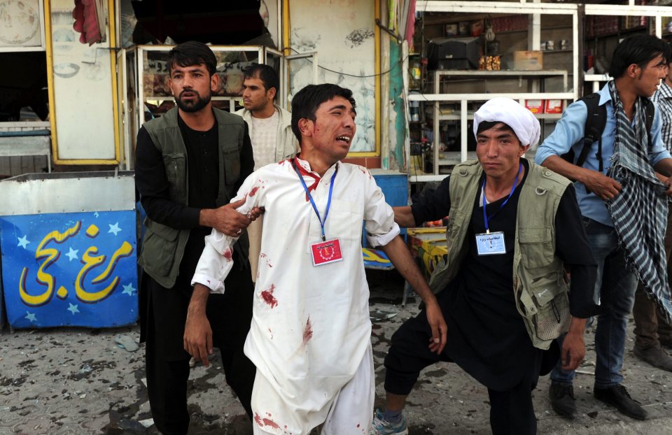  An injured man cries in despair after the attack in Kabul, Afghanistan