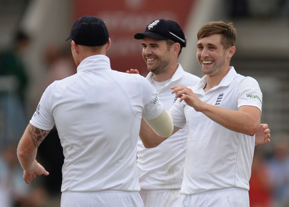 Chris Woakes celebrates with Stokes and Jimmy Anderson after taking his fourth wicket of the innings