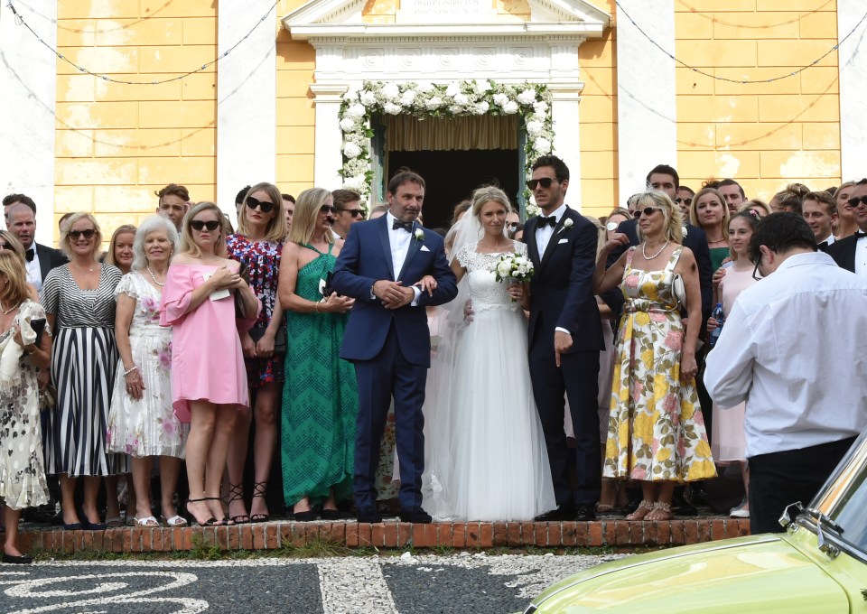  Their friends and family gather around them outside the wedding venue