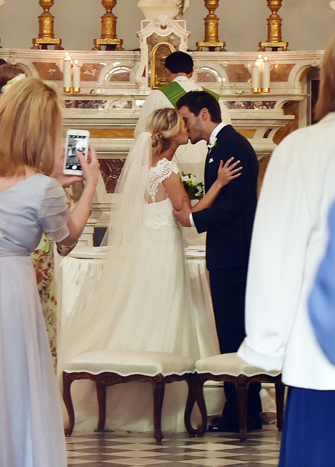  'I do'... Scarlett and Rob share their first kiss as man and wife after completing wedding vows