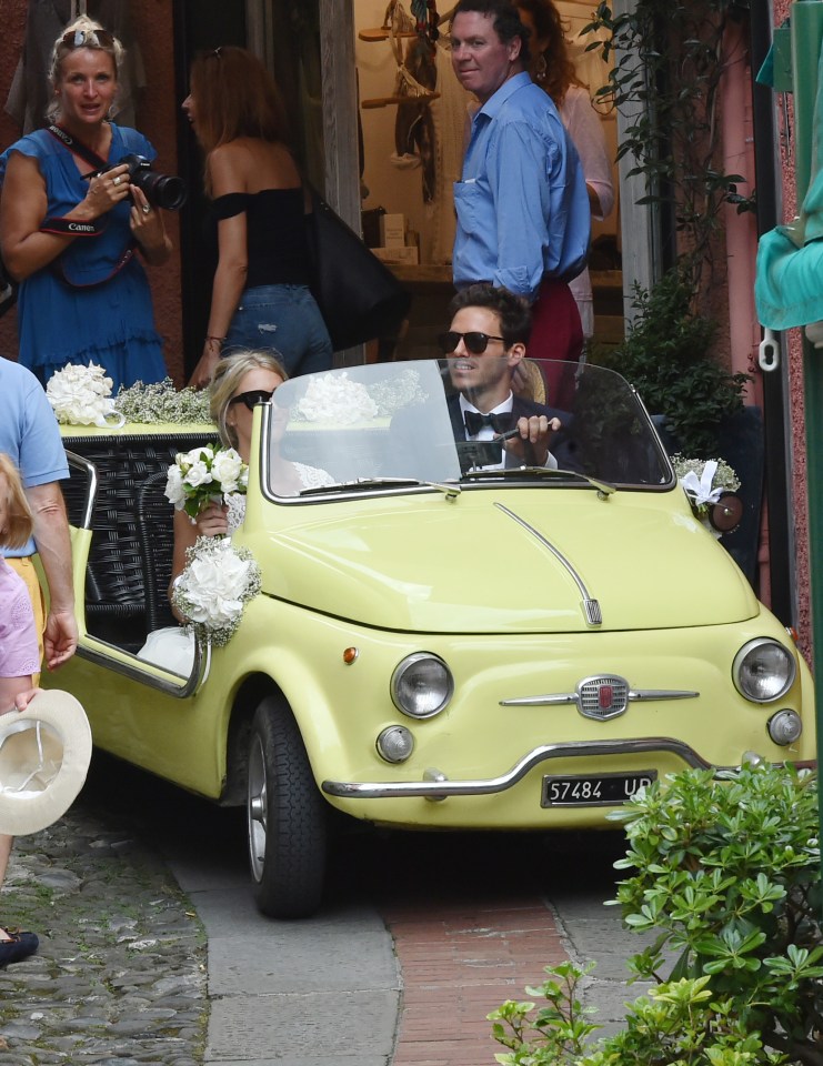  The newly weds set off on the next chapter of their adventure in a pale yellow Fiat 500 Jolly decked with flowers