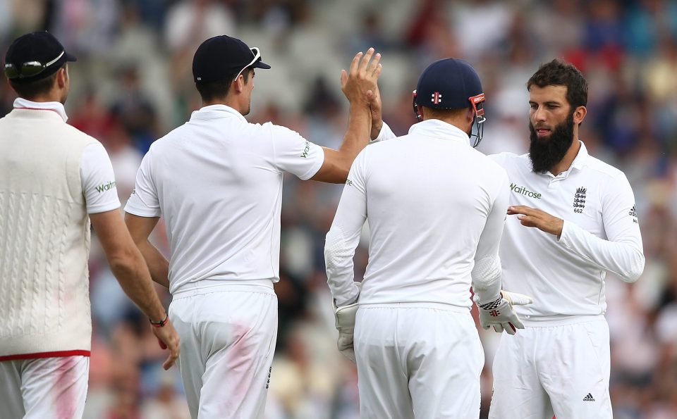 England players congratulate Moeen Ali after getting his first wicket off the match