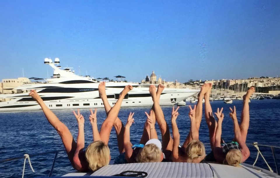  These women showed their dislike for the tycoon by baring their bums and sticking two fingers up as they passed his yacht