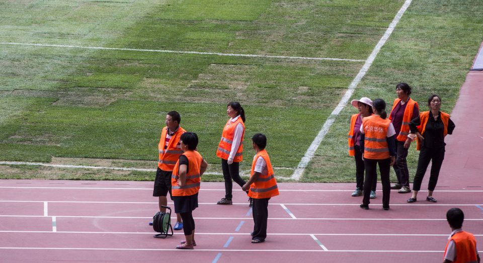  Staff inside the Bird's Nest beside the horrendous patchwork pitch