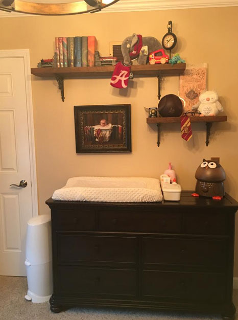  The baby changing area has a row of Harry Potter books above it