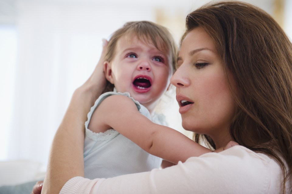 Mother consoling crying baby