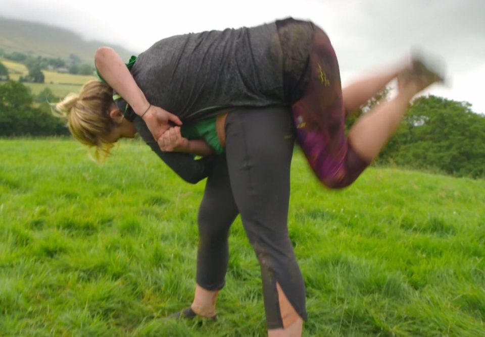  Head over heels ... Helen, 33, gets tipped in the air during mud wrestle