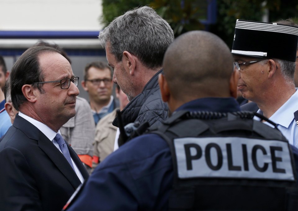  French President Francois Hollande (L) speaks with police forces in Saint-Etienne-du -Rouvray near Rouen in Normandy, France.