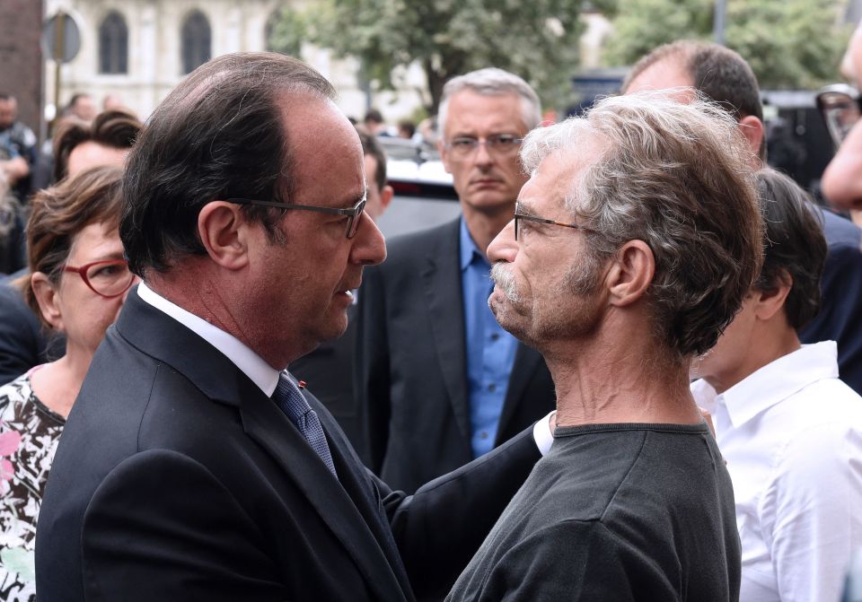  President Hollande embraces a local man in the town of Saint-Etienne-du-Rouvray