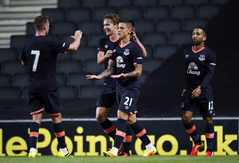  Teammates including Aaron Lennon surround midfielder Mo Besic congratulate his headed third goal