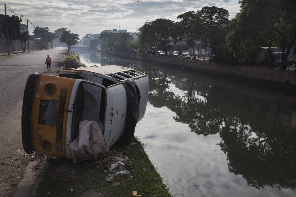  A turned over vehicle and garbage next to a canal in the Pica-Pau slum which flows into the Iraja river, which empties into Guanabara Bay,