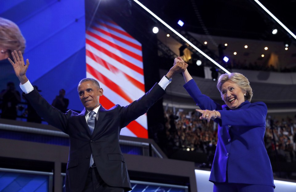  Obama hugged Clinton before holding her hand aloft