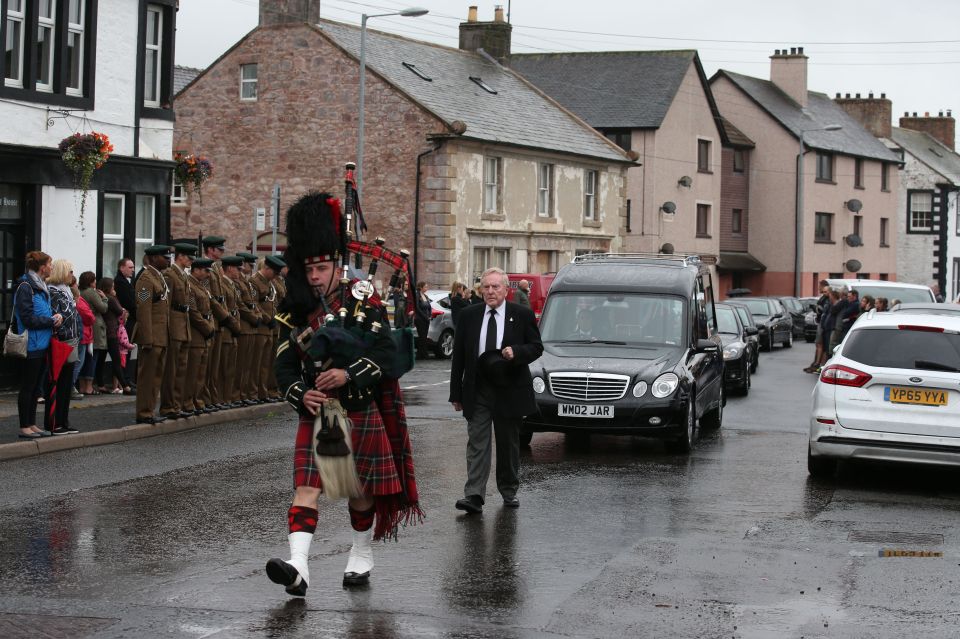 A lone piper led the procession down the streets of tiny Ecclefechan, a village near Lockerbie in Scotland