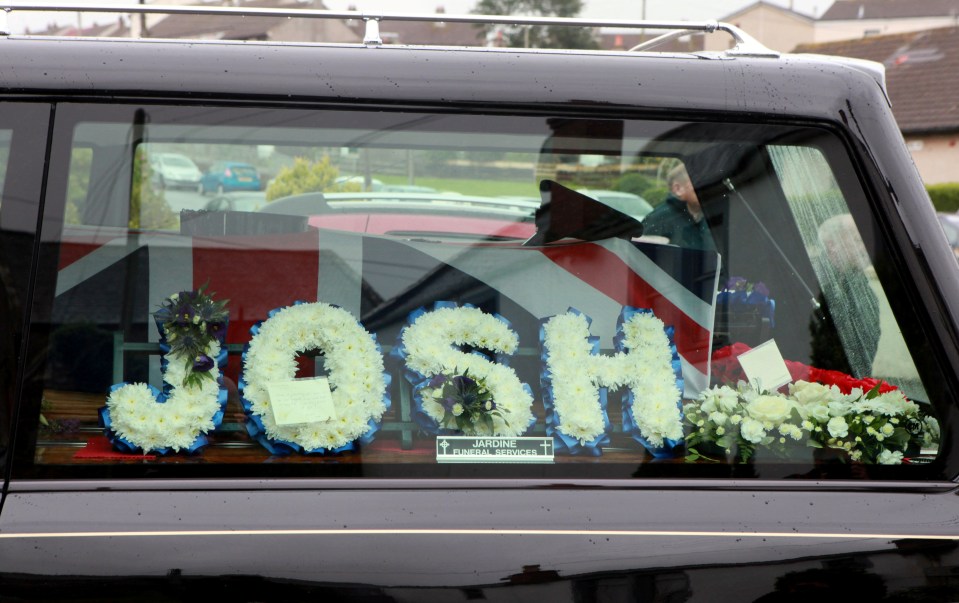 The coffin was adorned with a floral tribute in his name