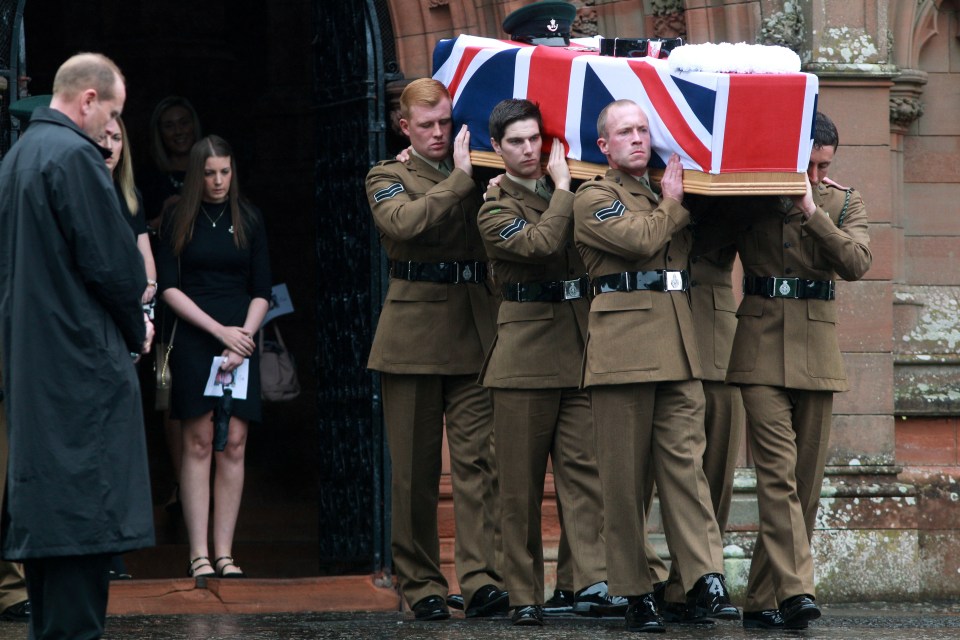 Rachael walks behind her partner's coffin as it is carried from the memorial centre