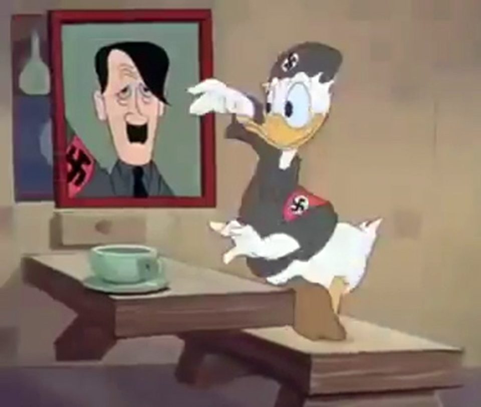  Donald Duck stands next to a painting of Adolf Hitler in the 1942 cartoon Der Fuehrer's Face that was banned in Russia for promoting extremism