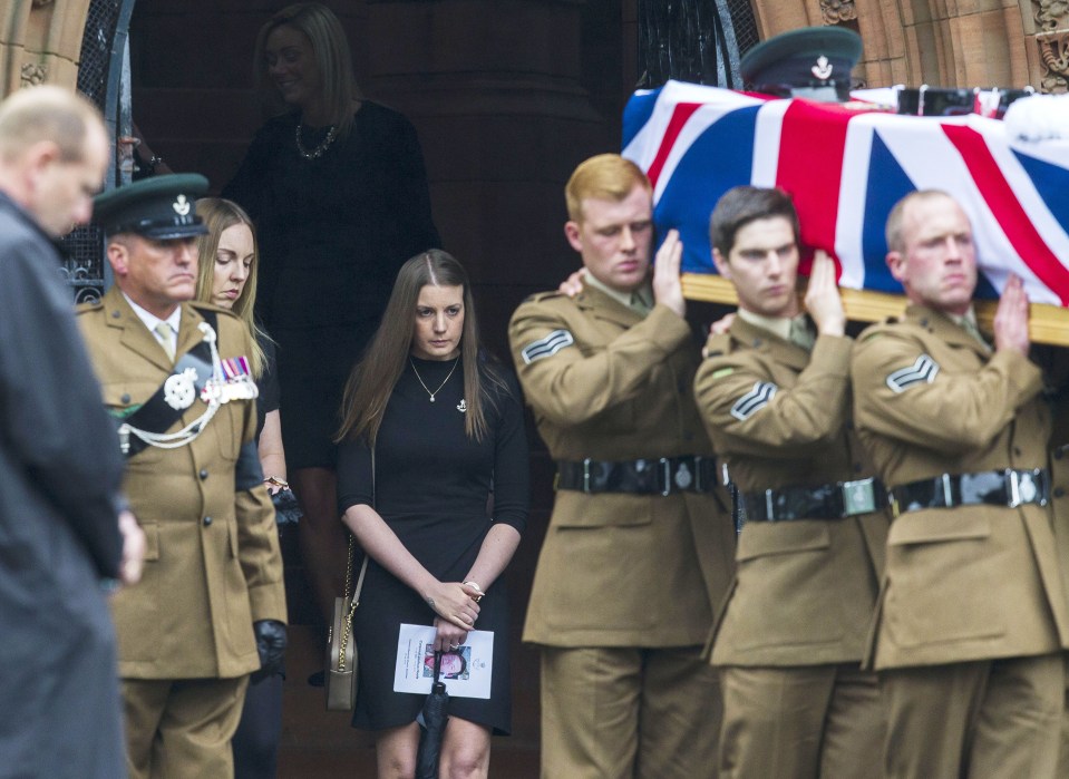 Corporal Josh Hoole's fiancee Rachael McKie looks on as her partner's coffin is carried from the memorial centre